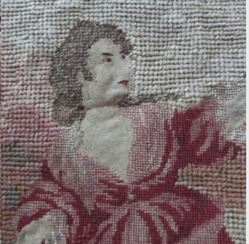 Woven or embroidered scene depicting a woman in a red dress, with previously damaged areas now stabilized and visually integrated.